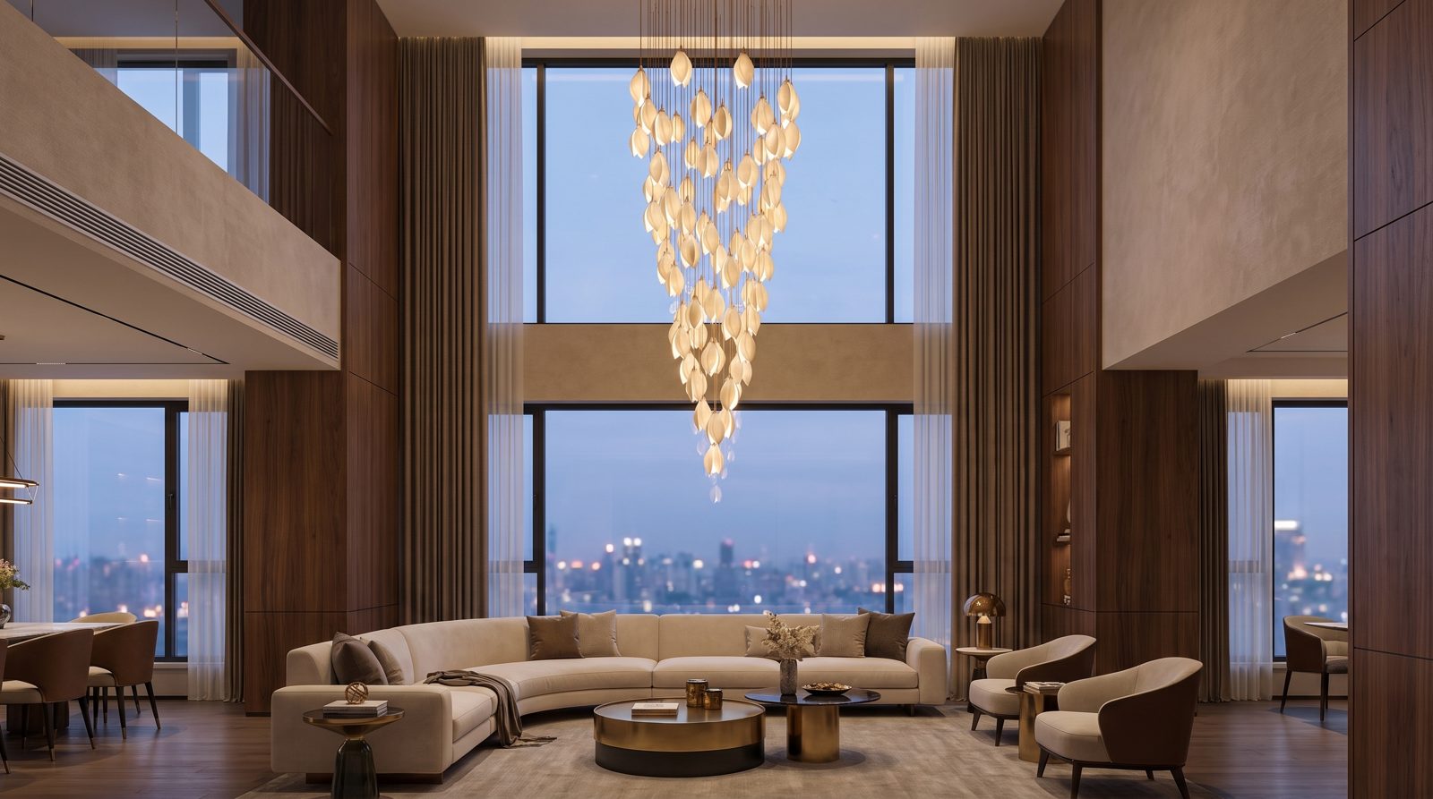 Large cascade chandelier in a double-height villa hall with tall glazing