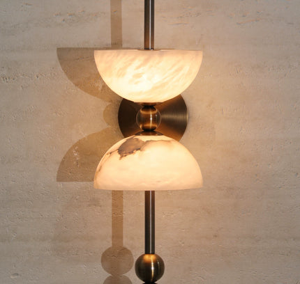 Wall Lamp ALBA by Rodesigne — lit on travertine wall